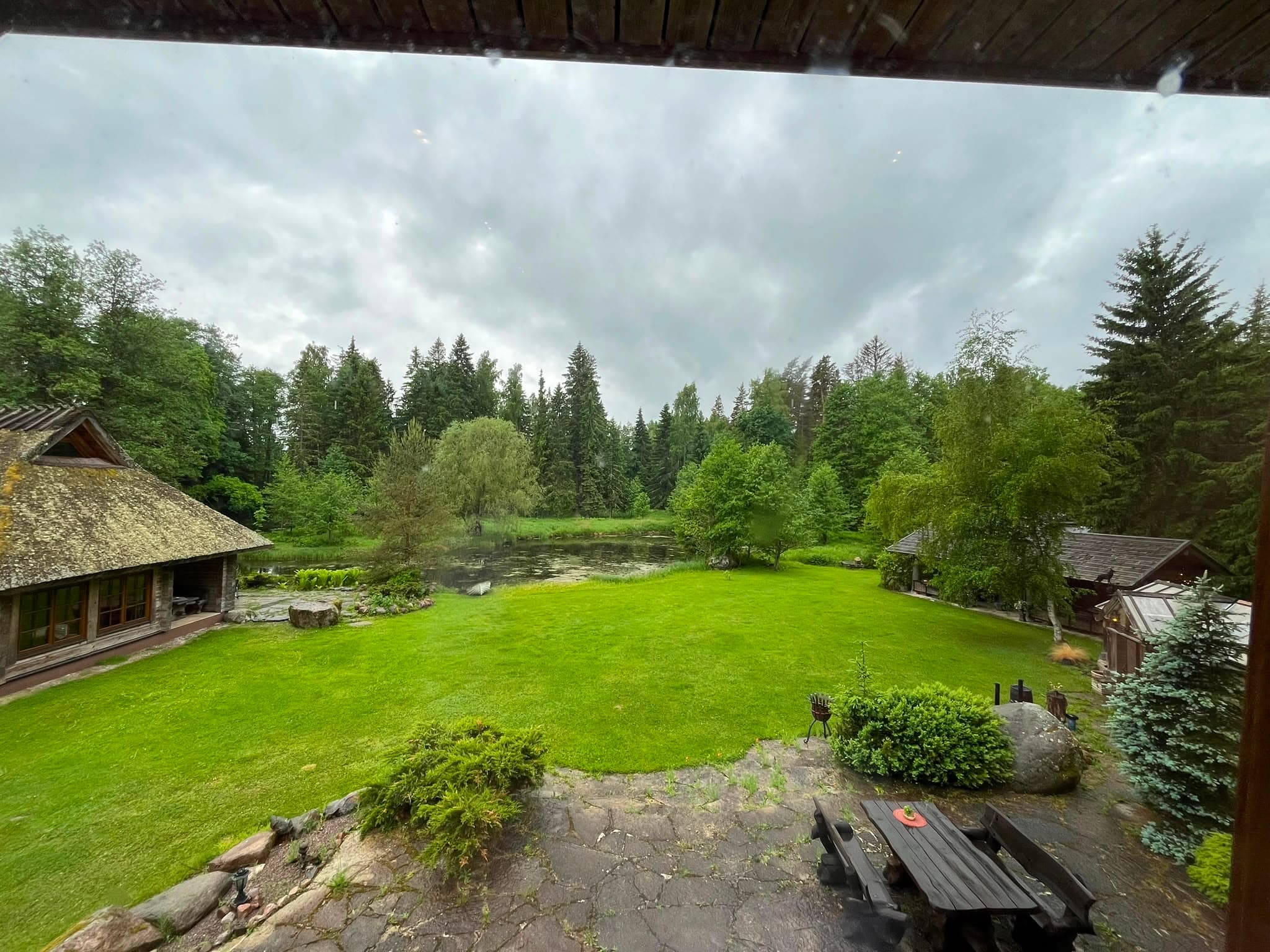 Open lawn before the main house under high cloud