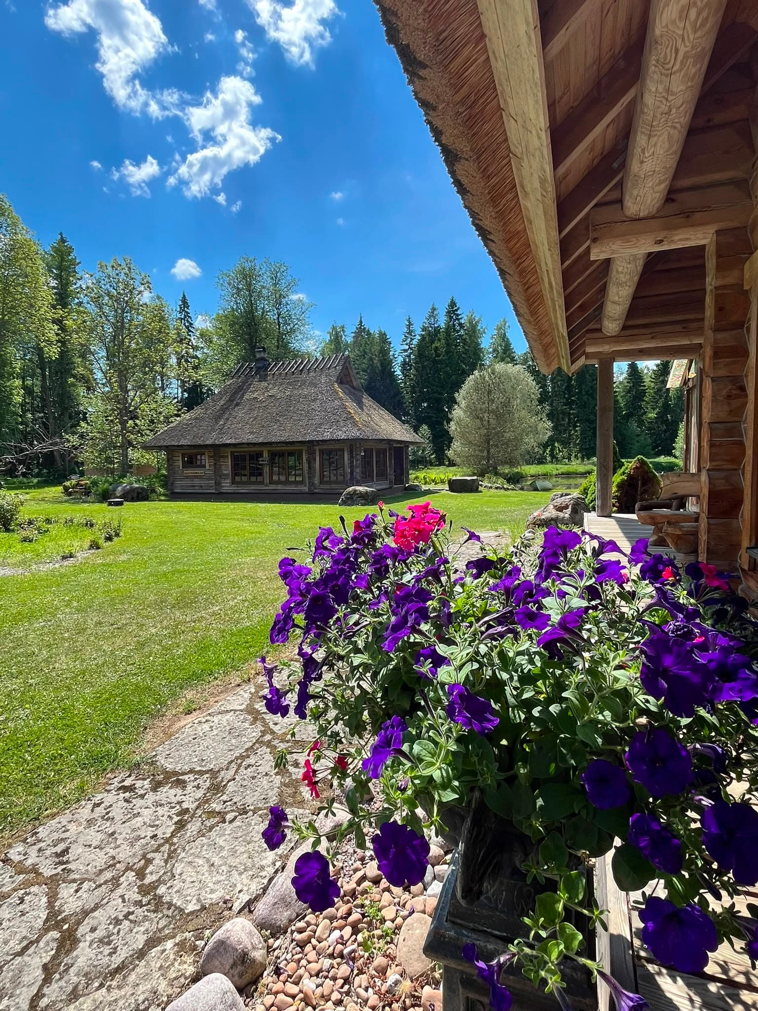 The sauna house and main house across the lawn