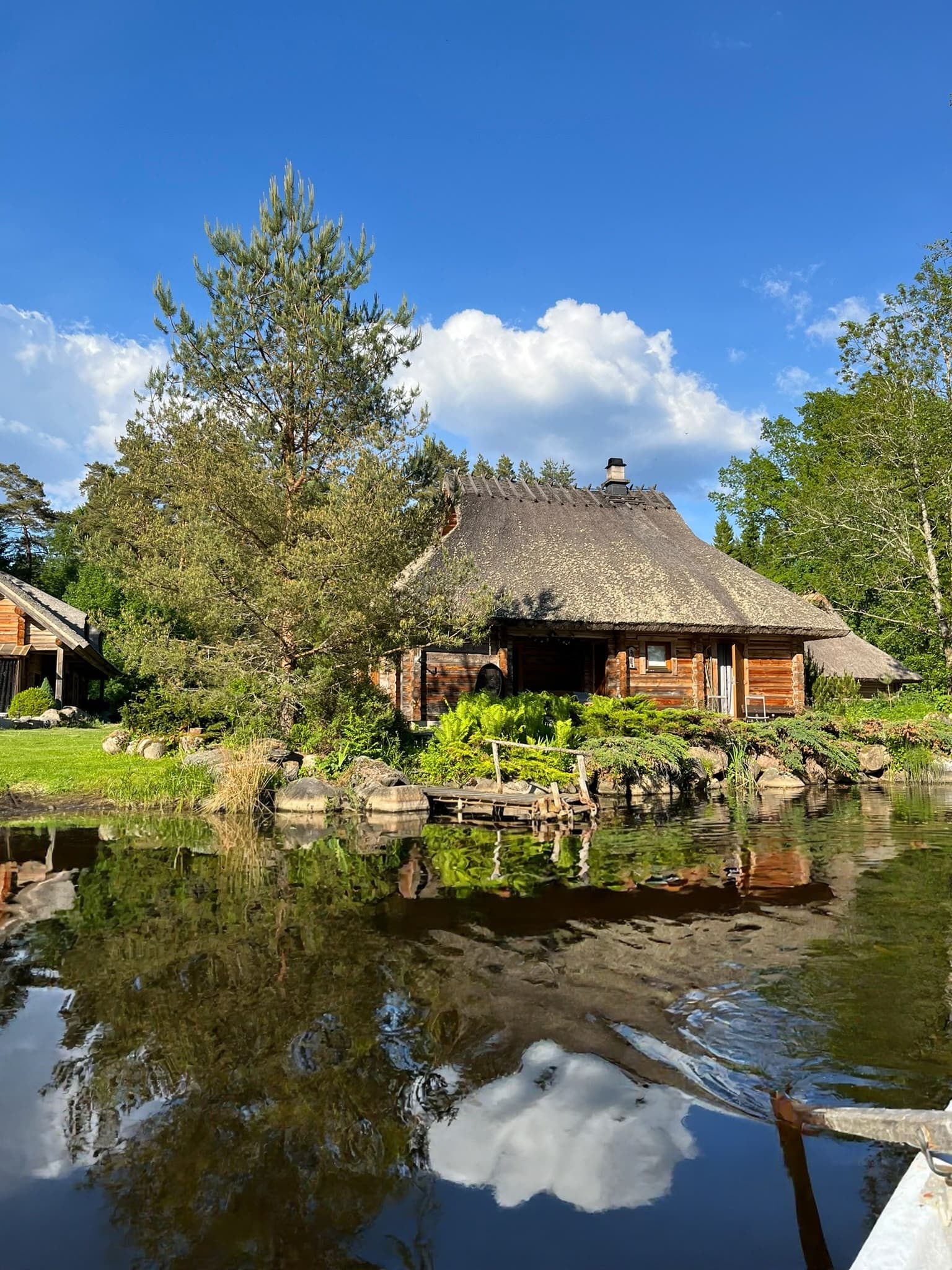 The Sauna House at the pond, forest mirrored in the water