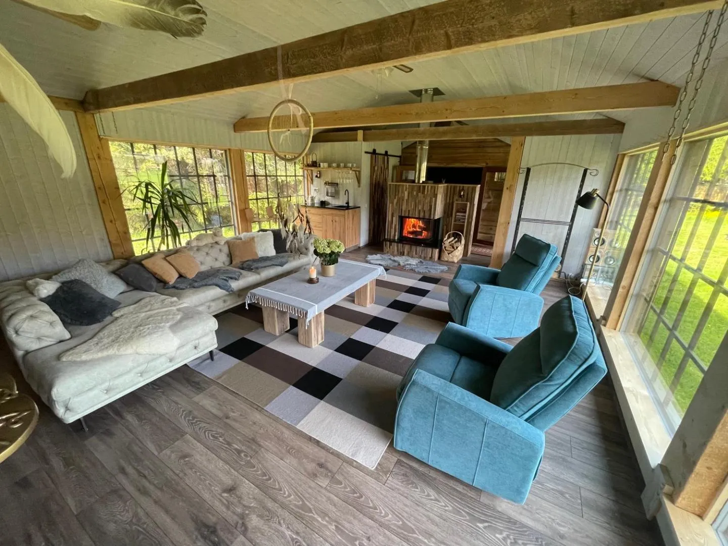 Forest House — the whole living room from above — the kitchen corner, the fire and the checked rug