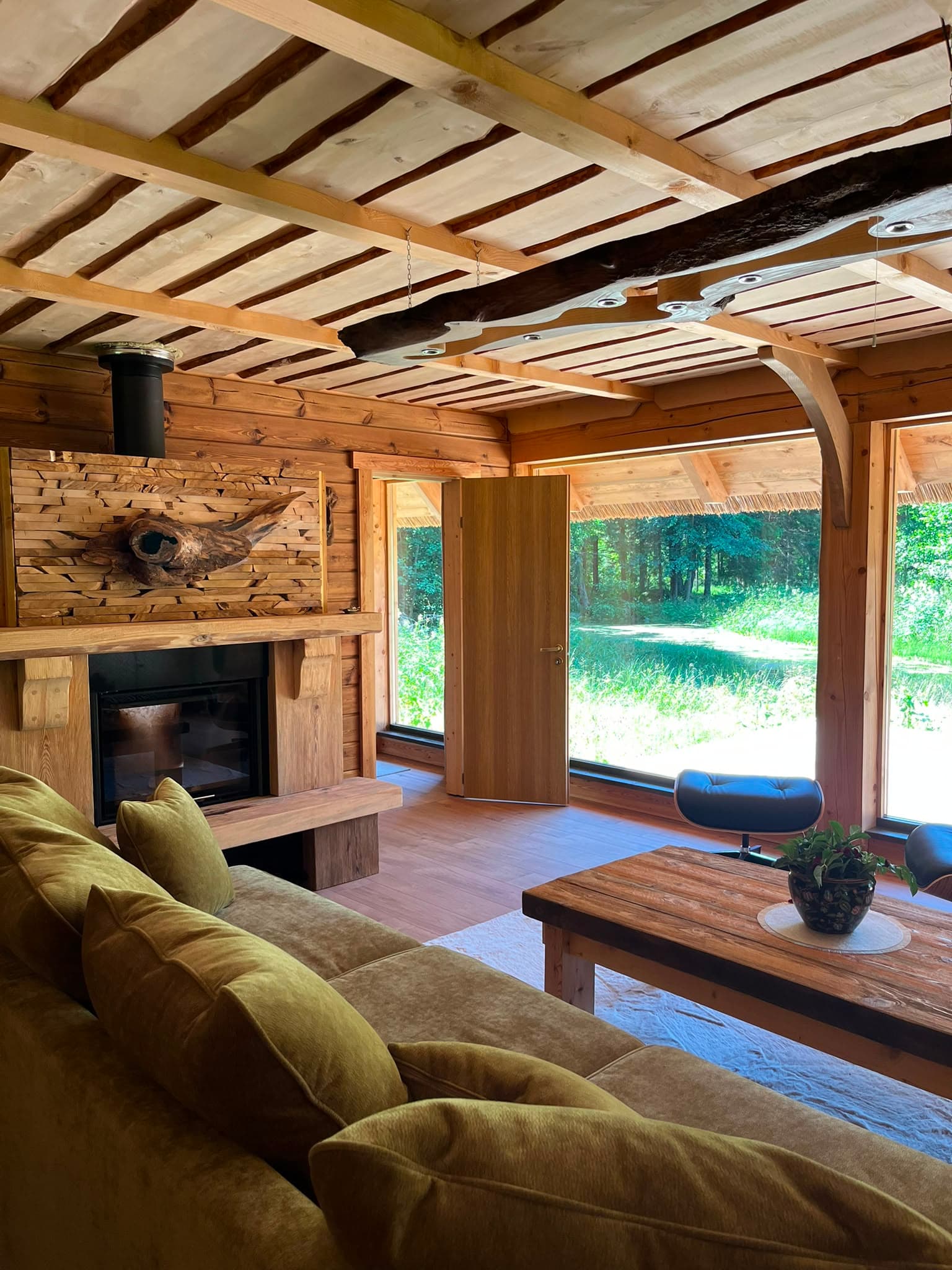Pond House — the fireplace and glass walls opening onto lawn and forest